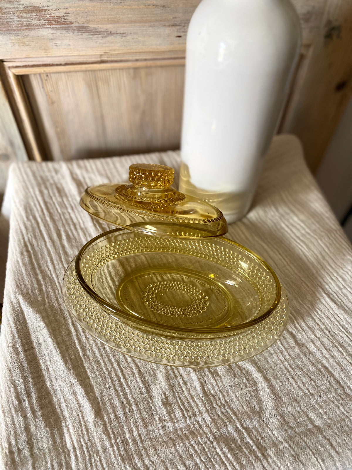 Beurrier ovale en verre ambré moulé, décor perlé - 1960